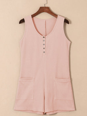 Blush pink waffle knit button-down romper with pockets and a scoop neckline.