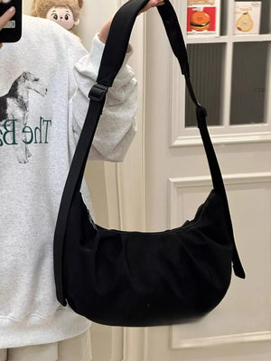 Black crescent shape crossbody bag with adjustable strap