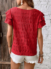 Red textured smocked blouse with ruffle sleeves.