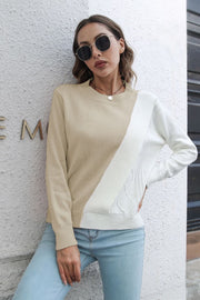 Beige and white acrylic sweater with diagonal colorblock and cable knit details.