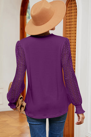Violet knit top with lace long sleeves and ruffled cuffs.