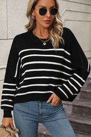 Black and white striped boxy knit sweater with crewneck and relaxed fit.