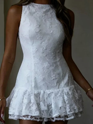 White lace mini dress with a ruffled hem and high neckline.