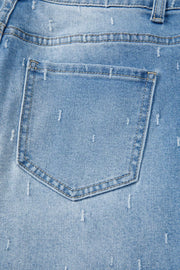 Light wash denim jeans with distressed details and raw hem.