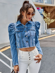 Medium wash denim jacket with puffed sleeves, button front, and raw hem