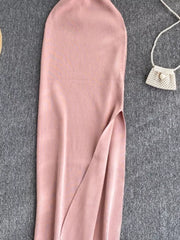 Pink ribbed knit midi dress with a high slit and a cutout detail.