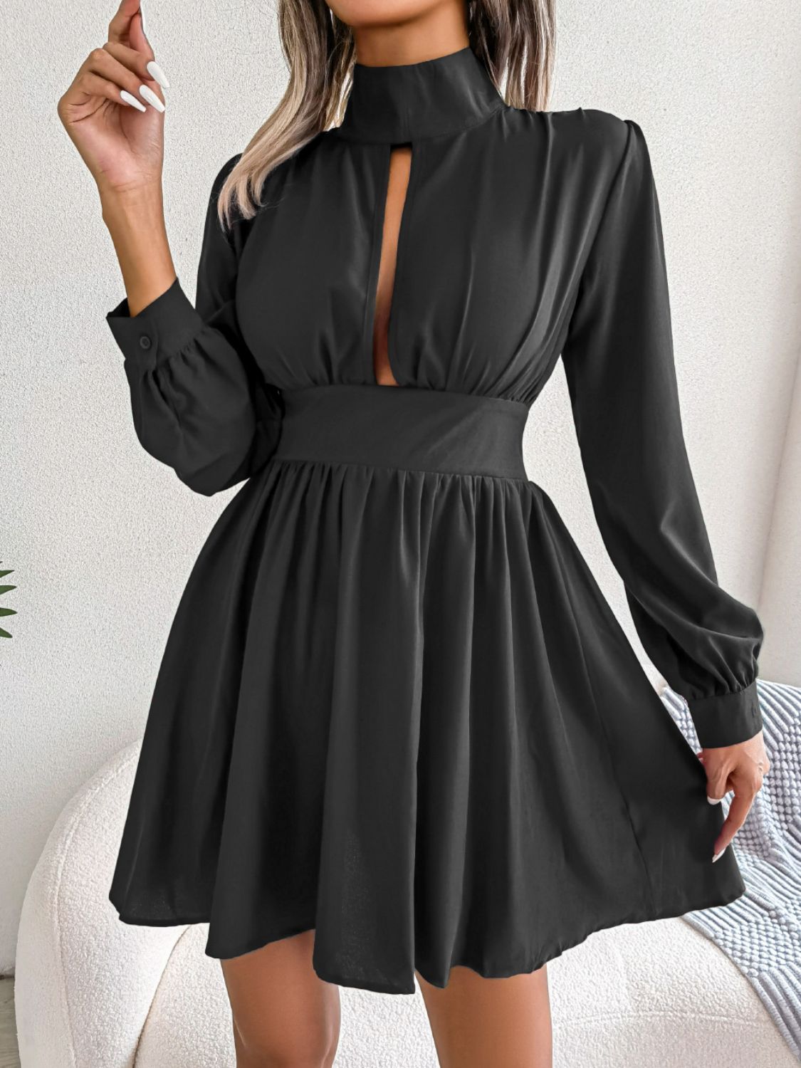 Black fit-and-flare mini dress with keyhole neckline, long balloon sleeves, and gathered waist.