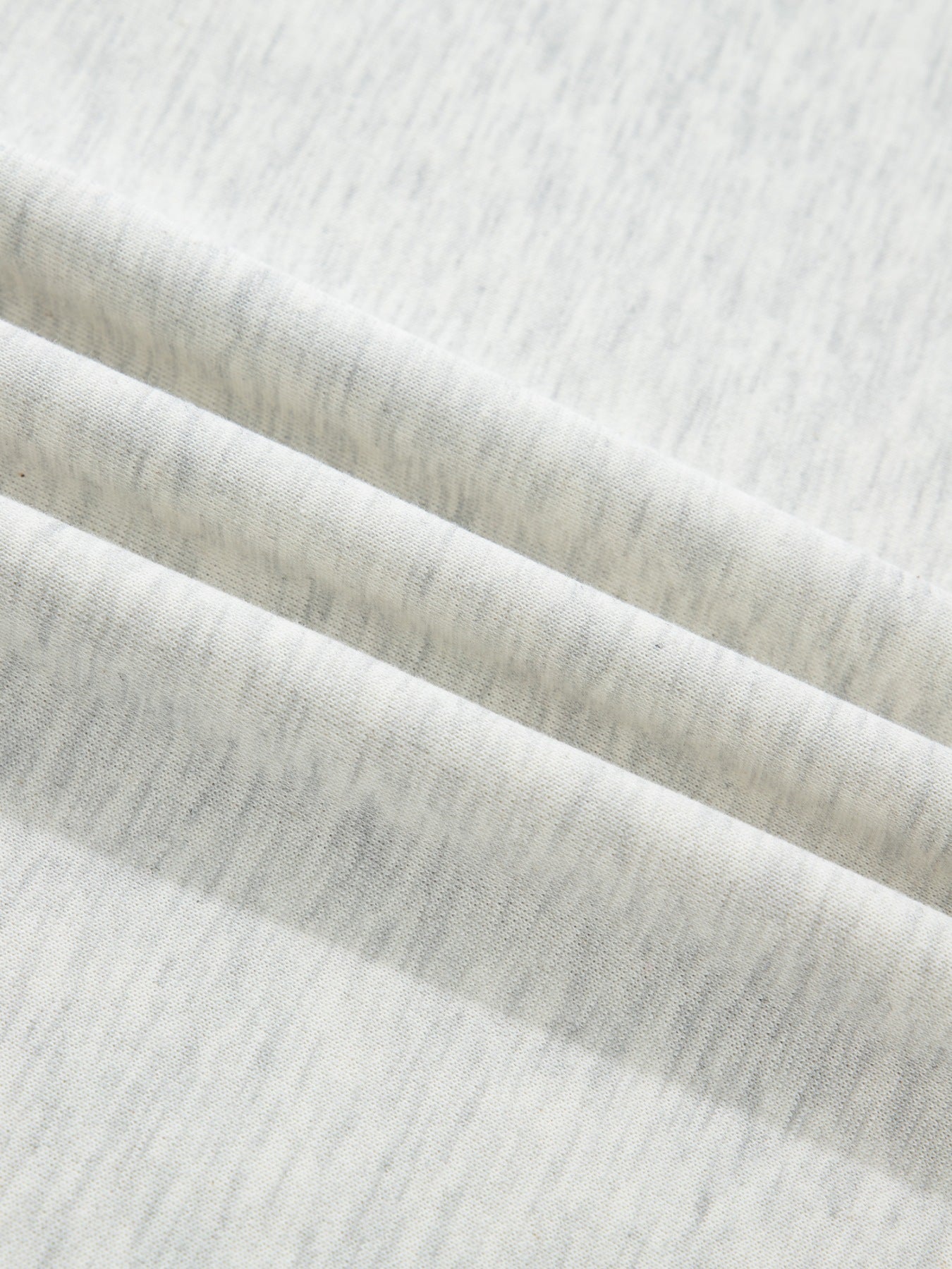 Light grey marled cotton casual top with button detail, showing fabric texture.