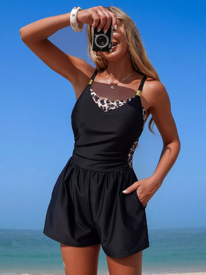 Chic black one-piece swimsuit with leopard print trim and shorts.