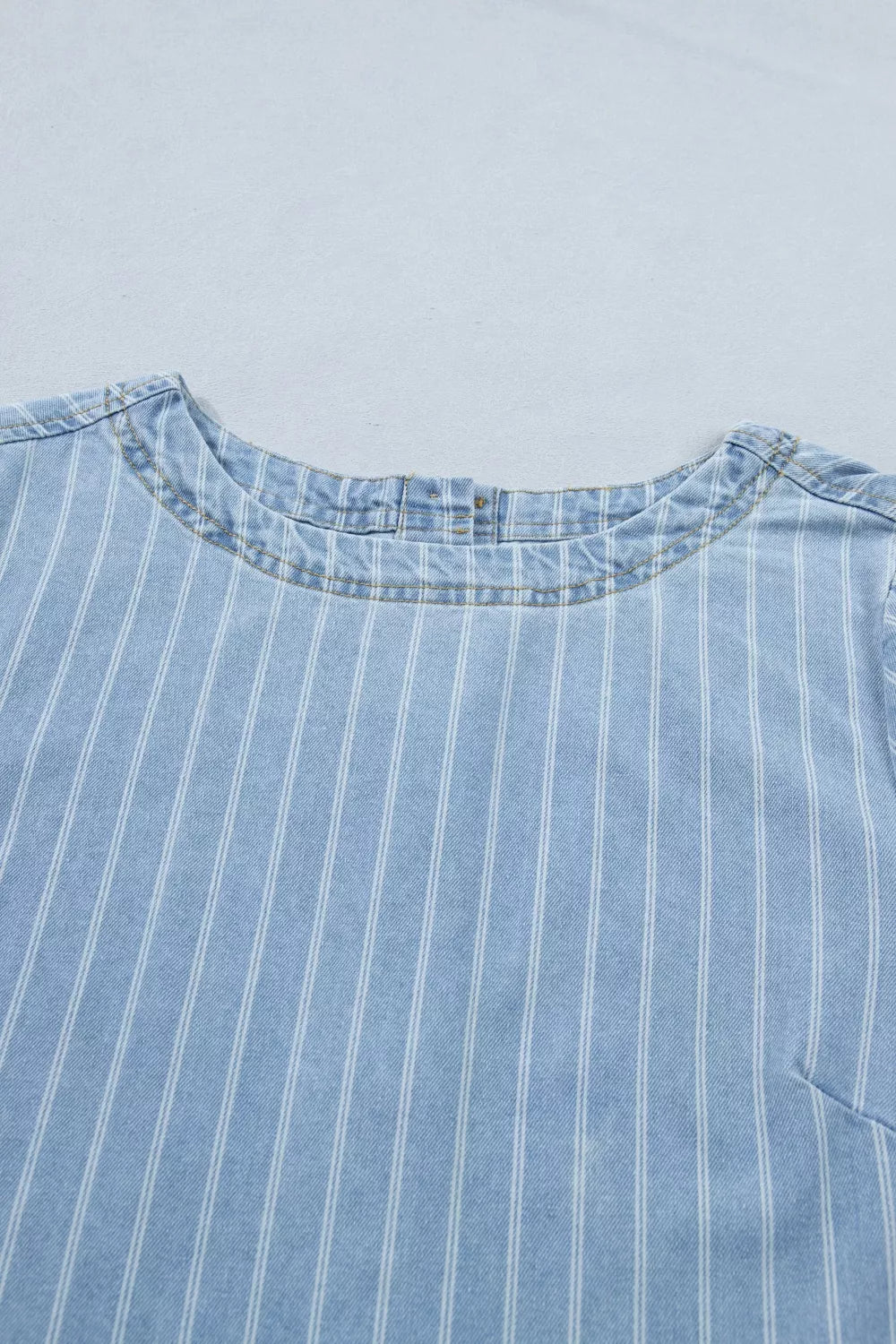 Light blue denim mini dress with white vertical stripes and a crew neck.