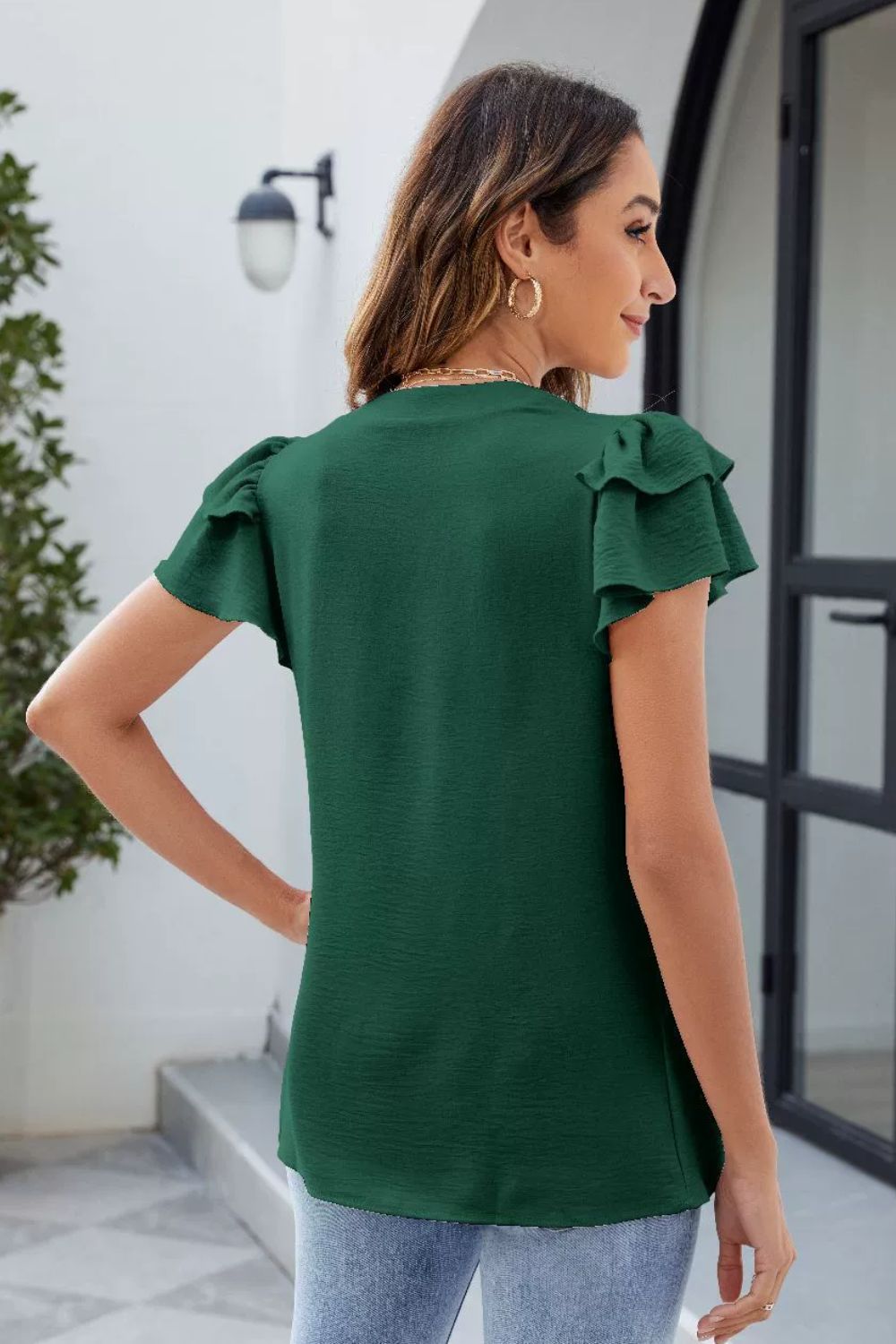 Dark Green textured V-neck blouse with flutter sleeves.