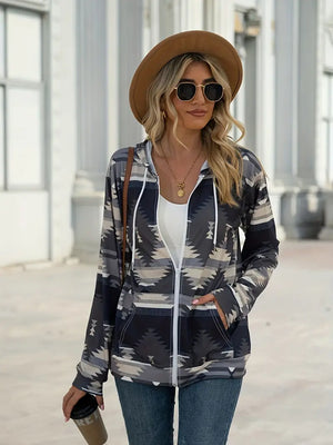 Aztec print zip-up hooded jacket in gray with white zipper and drawstring.