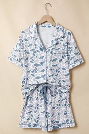 Blue camouflage print button-down pajama set with short sleeves and drawstring shorts.