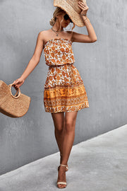Caramel floral print bandeau mini dress with smocked bodice and tiered skirt.