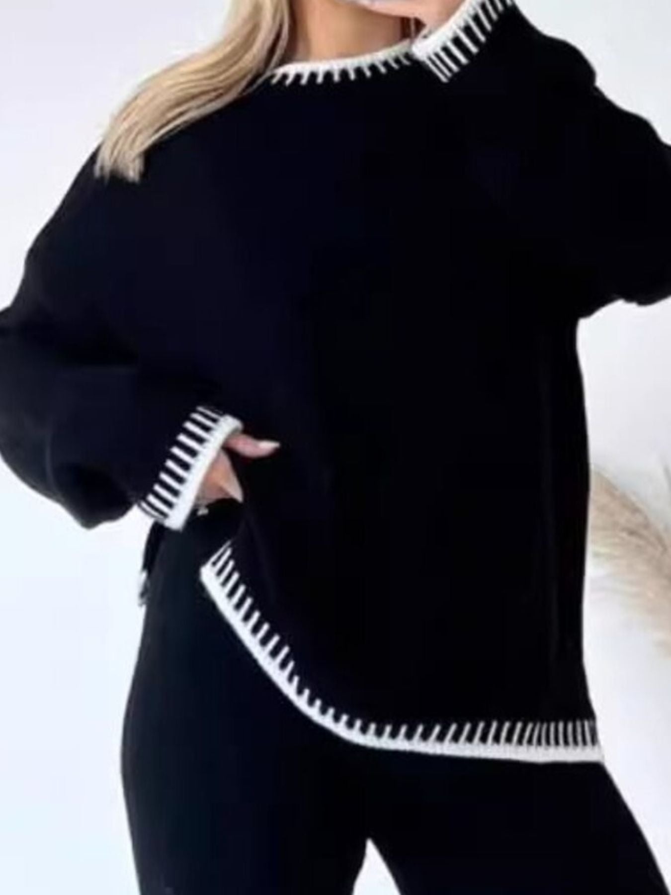 Black relaxed fit sweater with white contrast trim detail on neckline and hem