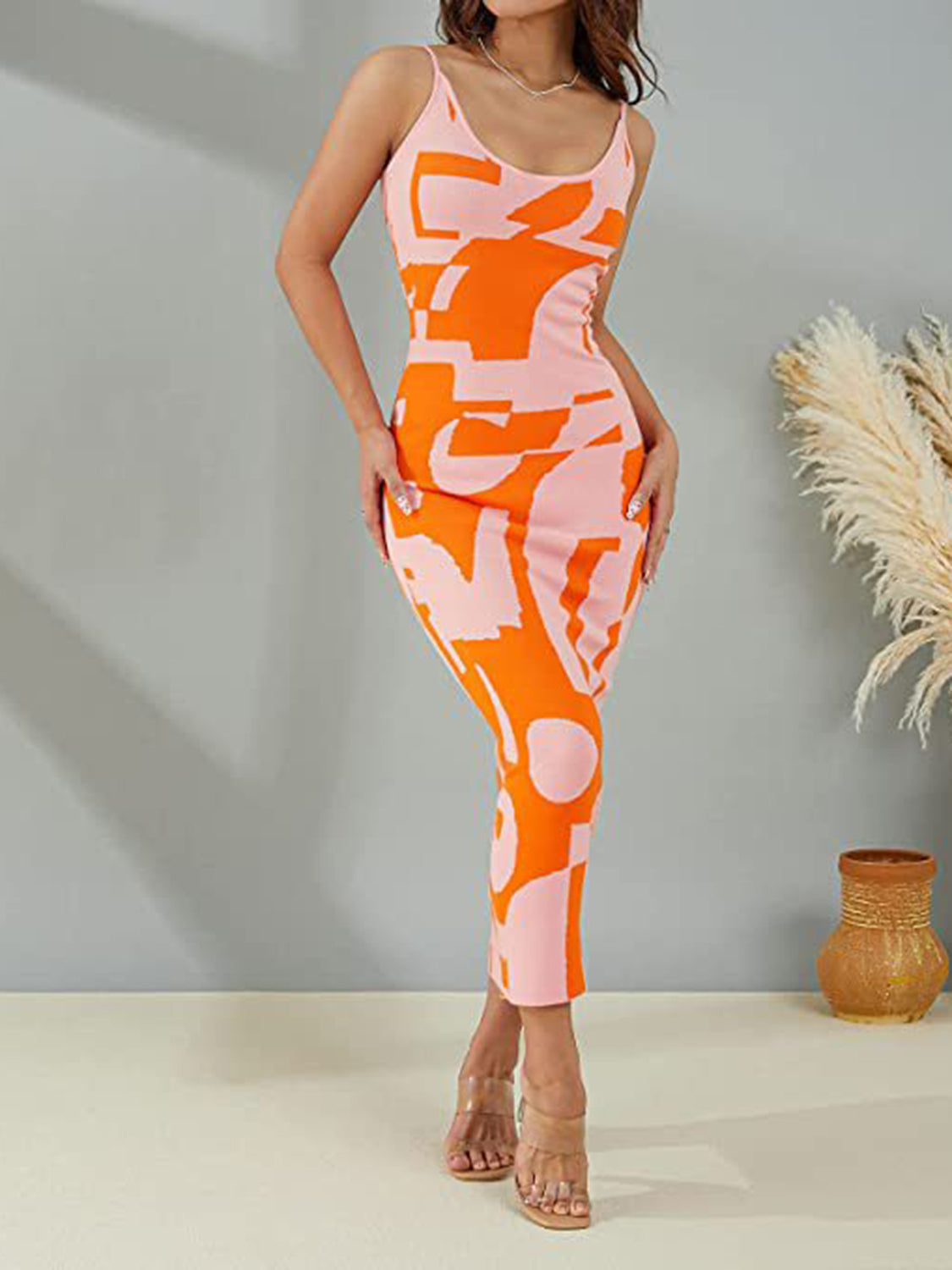 Geometric knit maxi slip dress in orange and pink abstract print with scoop neck.