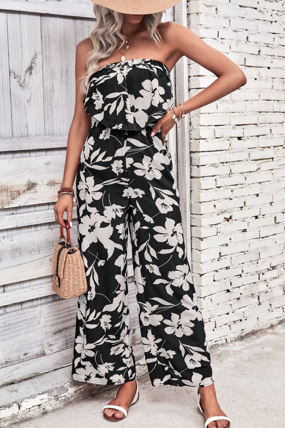 Black floral ruffle bandeau palazzo jumpsuit with wide legs.