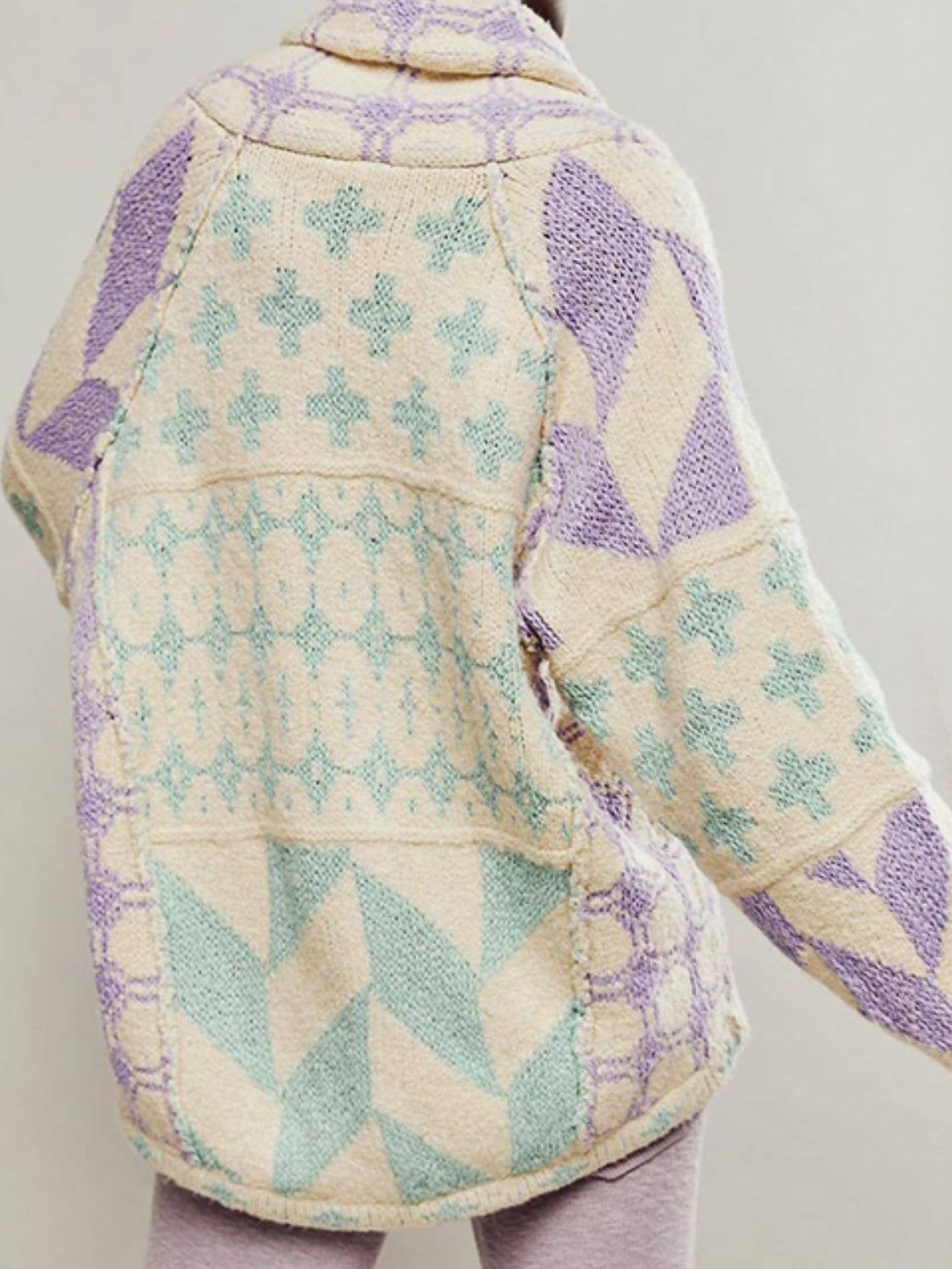 Geometric patchwork knit cardigan with cream, purple, and mint green patterns.