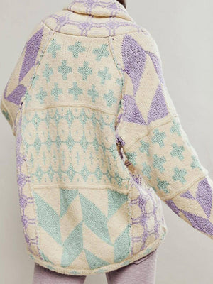 Geometric patchwork knit cardigan with cream, purple, and mint green patterns.