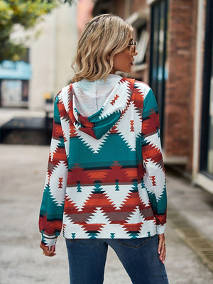 Aztec print zip-up hooded jacket in teal, rust, and white with a relaxed fit.