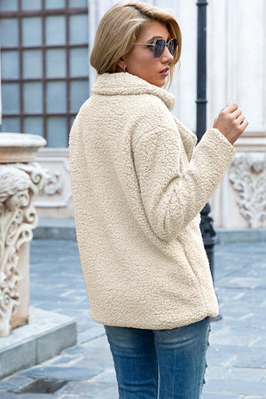 Cream teddy pea coat with a double-breasted design and wide lapels.