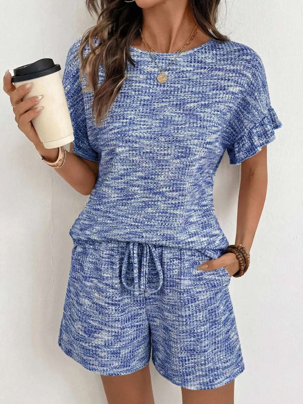 Blue ruffled sleeve two-piece set with drawstring shorts and textured fabric.