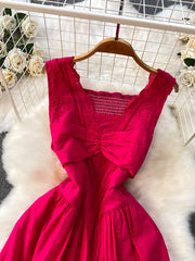Charming eyelet maxi dress in hot pink with cutout detail and smocked bodice.