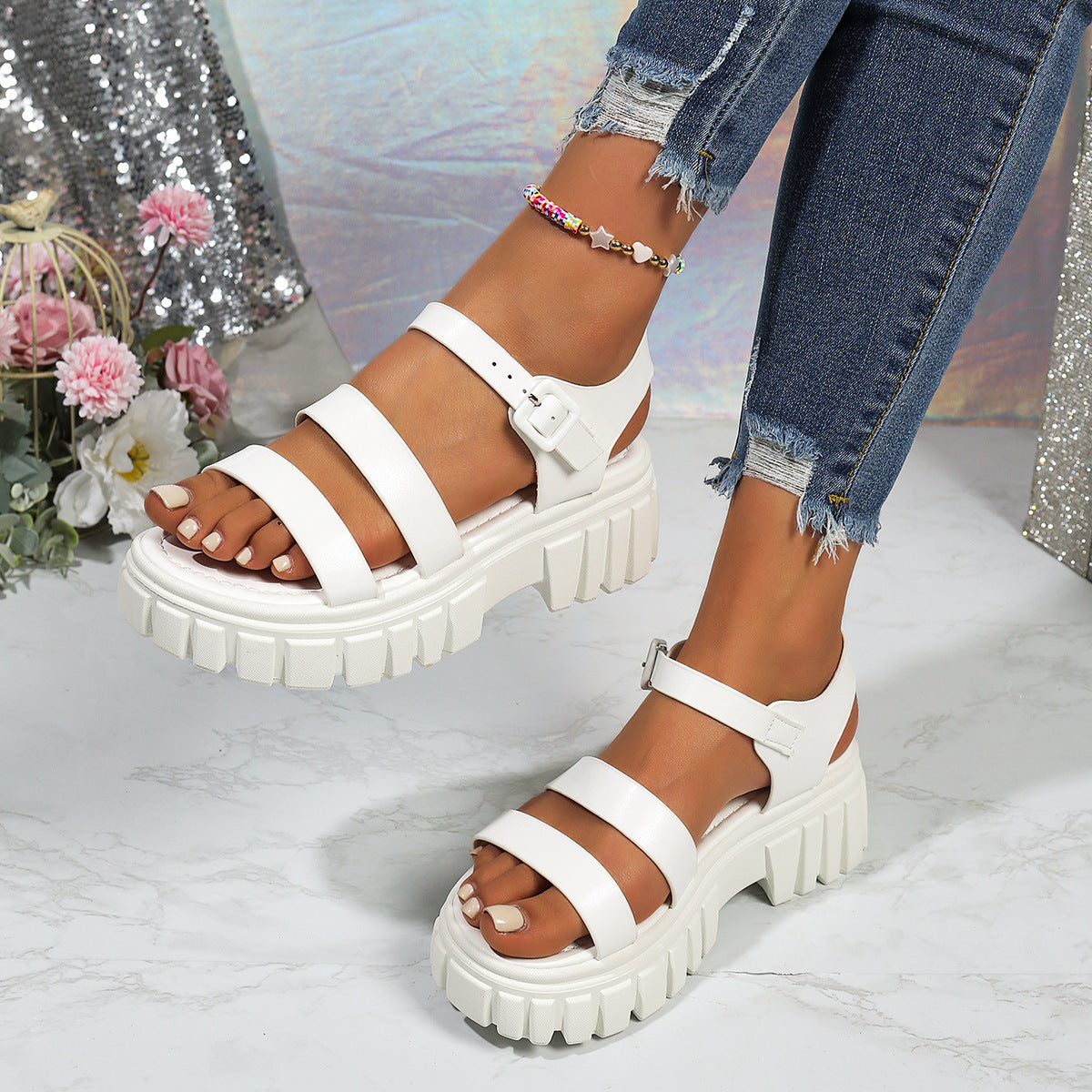 White open-toe platform sandals with three straps and buckle closure.