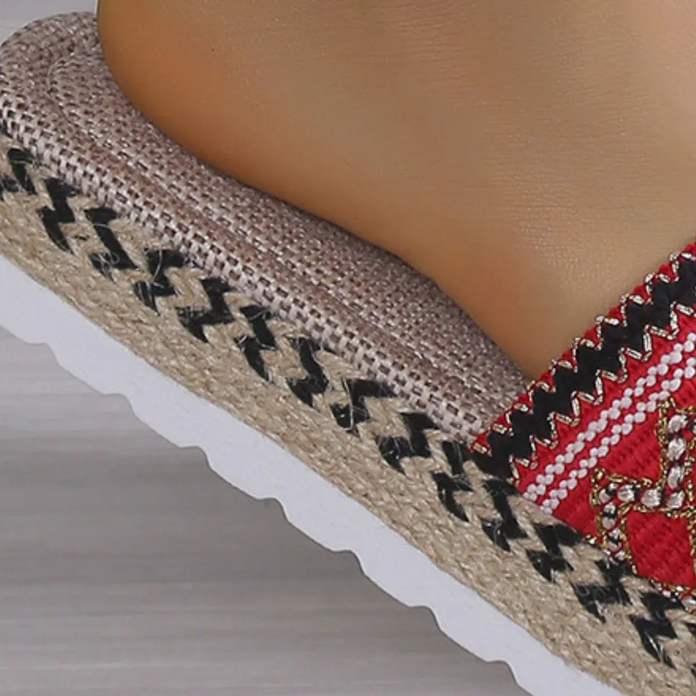 Embroidered espadrille platform slides with red, white, and black zigzag trim.