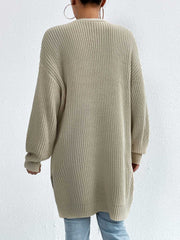 Longline knit open cardigan in beige acrylic with ribbed texture and relaxed fit.