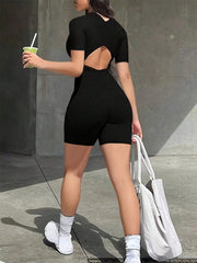 Black short-sleeve romper with a cutout back detail and biker shorts.