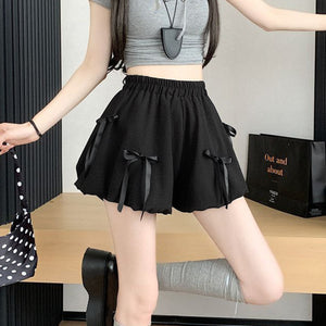 Black high waist bubble skirt with bowknot details and elastic waistband.