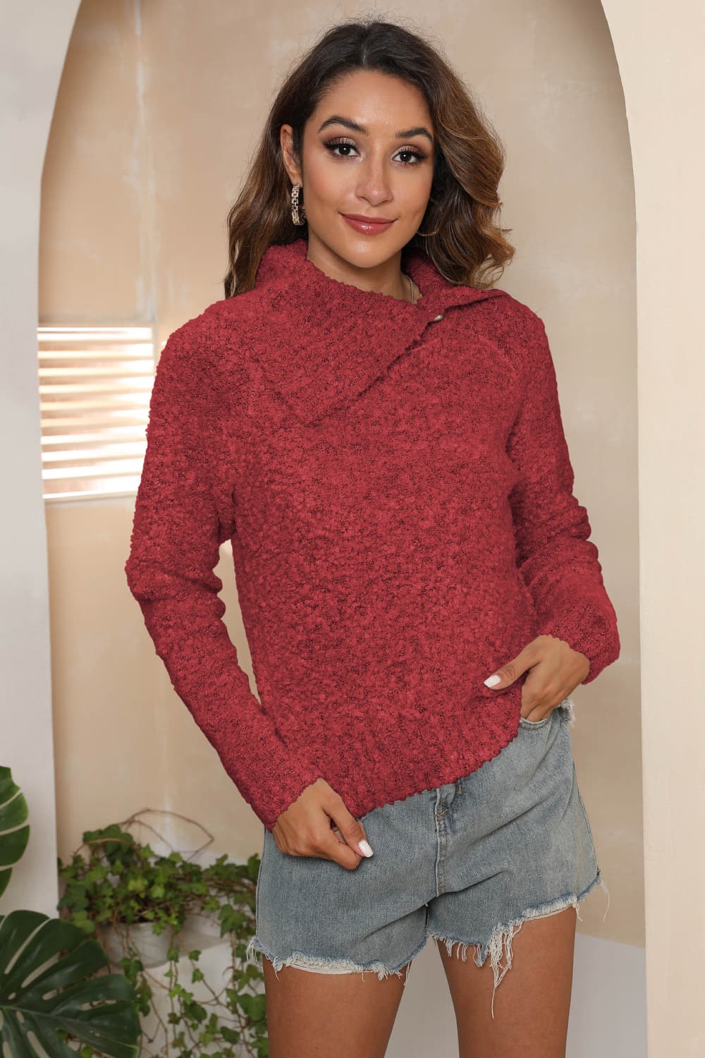 Deep Red textured knit sweater with asymmetric collar and long sleeves.