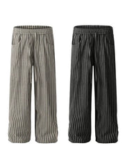 Men's striped drawstring sweatpants in black and gray cotton with pockets.
