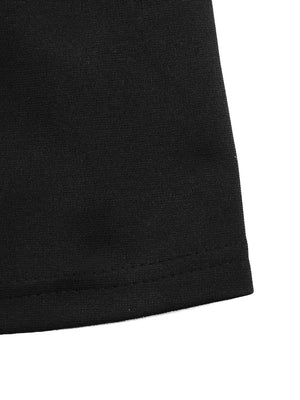 Black A-line mini dress hem detail with visible stitching.