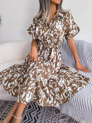 Mocha dalmatian print midi shirt dress with tie waist and short sleeves.