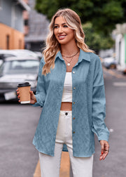 Sky blue textured overshirt with relaxed fit and button front, styled open over a white crop top.