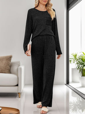 Black ribbed knit loungewear set with long sleeves, crew neck, chest pocket, and wide-leg pants.