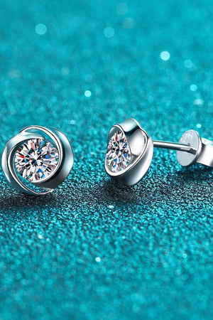 Silver halo crystal stud earrings with a swirling design.