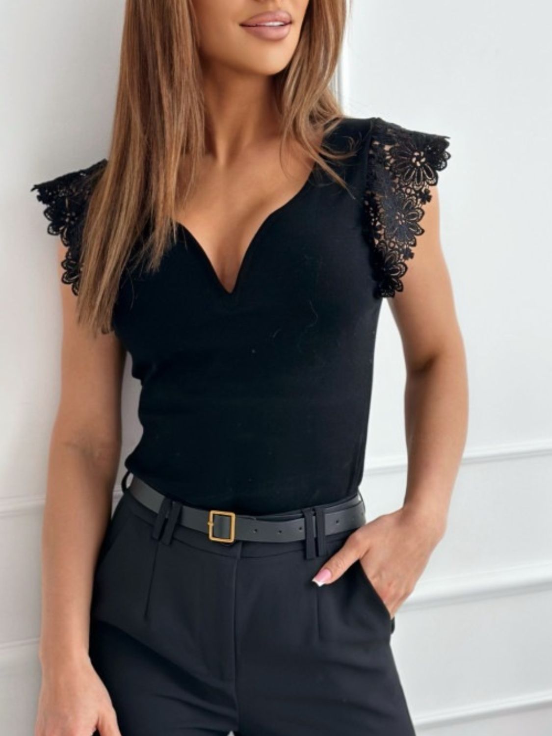 Black lace-trimmed plunge neckline top with cap sleeves.