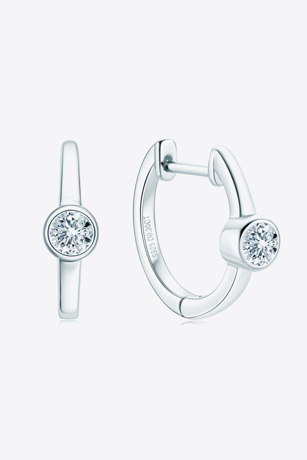 Silver bezel-set sparkle huggie hoop earrings with a single clear stone.