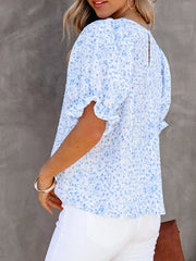 Sky blue floral print maternity blouse with ruffle sleeves and smocked bodice.