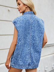 Denim leopard print sleeveless shacket in medium wash with a collar.