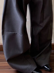 Men's gray wide leg pleated sweatpants with a relaxed fit.