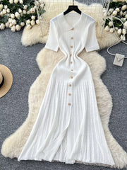 White knit dress with Peter Pan collar, short sleeves, and gold button details.