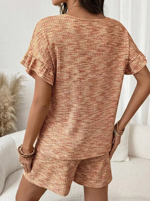 Orange-red ruffled sleeve two-piece set with textured fabric and drawstring shorts.