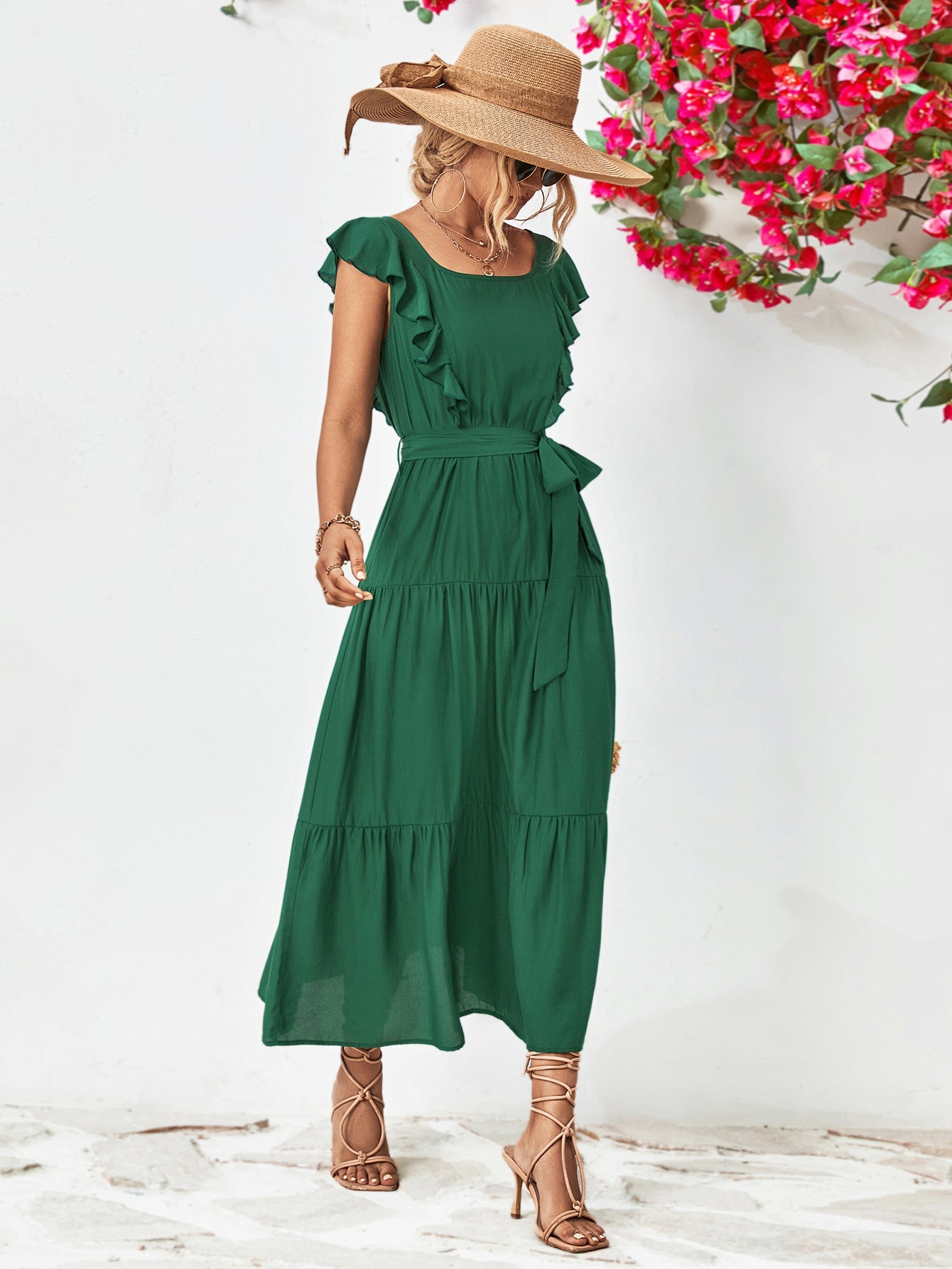 Forest green tiered midi dress with flutter sleeves and a belted waist.