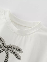 White cotton baby tee with playful abstract palm tree graphic and crew neck.