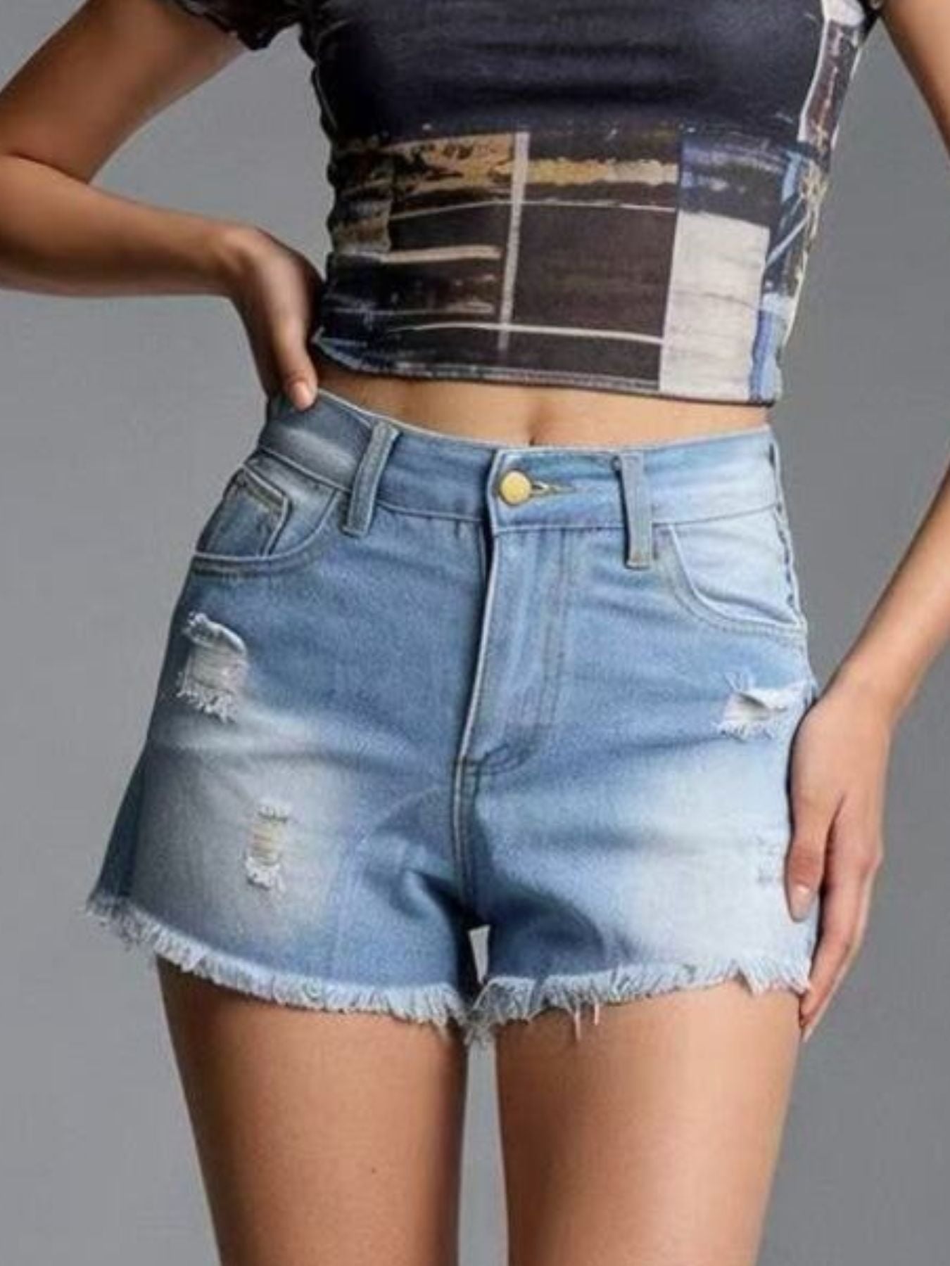 Light blue distressed denim shorts with frayed hem and high waist.