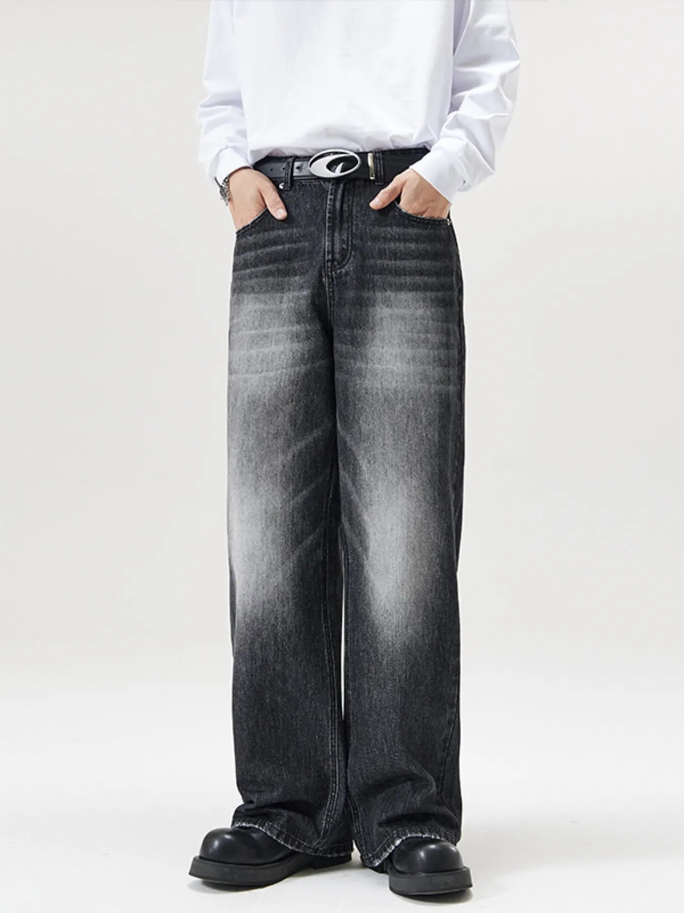 Men's wide-leg wash denim jeans in black with a faded effect.